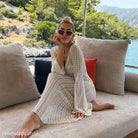 Woman in a crocheted summer beach dress perfect for pairing with a beach bikini swimsuit