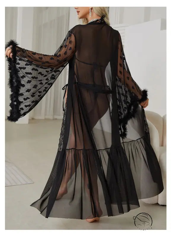 Sheer black robe with wide sleeves, polka dot pattern, and feathered trim.