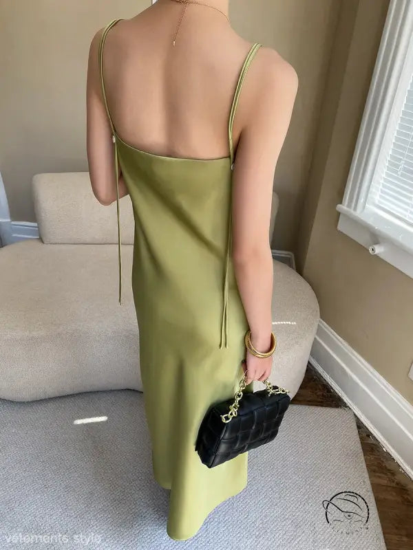 Budding green satin glossy cami dress with black quilted handbag