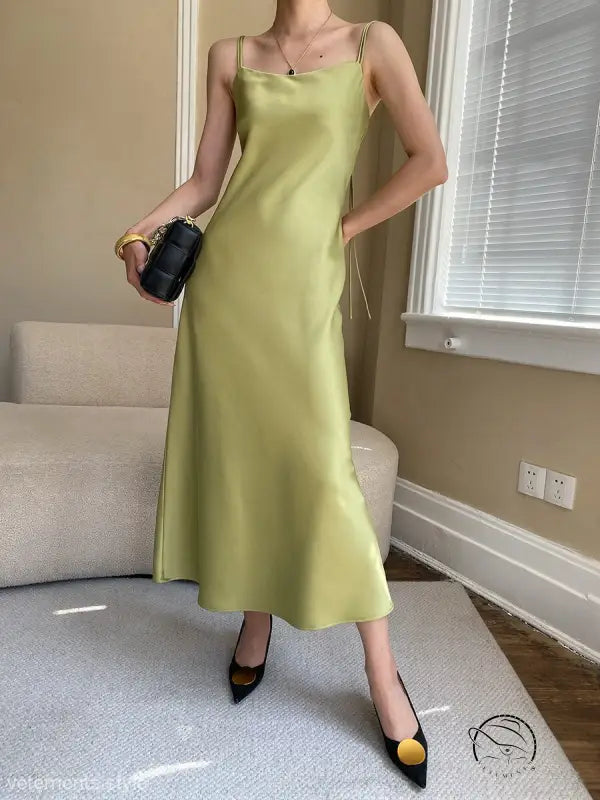 Budding green satin glossy cami dress with spaghetti straps and floor-length drape