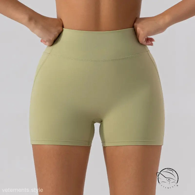 Olive green close fitting yoga shorts in sporty slim nylon