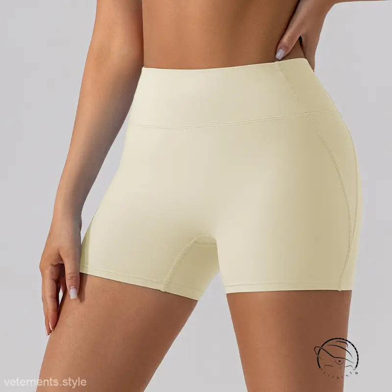 Cream-colored close fitting yoga shorts in oat apricot nylon
