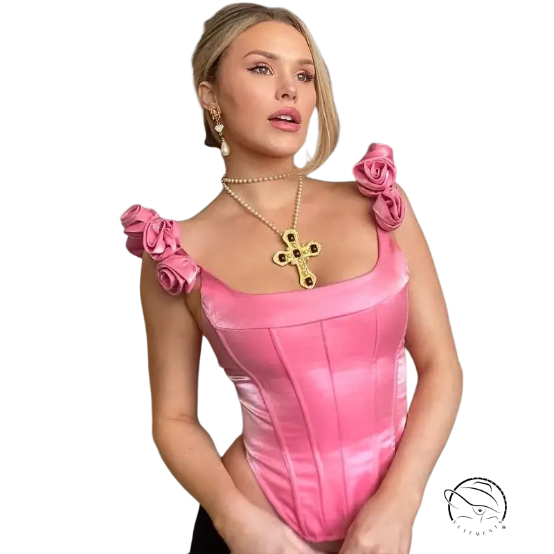 Woman in candy pink boning corset top with rose shoulders and cross necklace