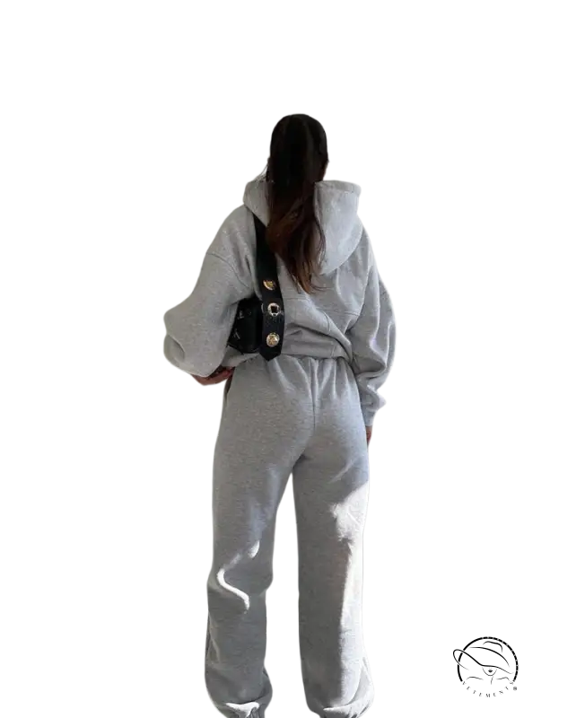 Person in casual comfy sweaters two-piece winter solid color set with dark crossbody bag