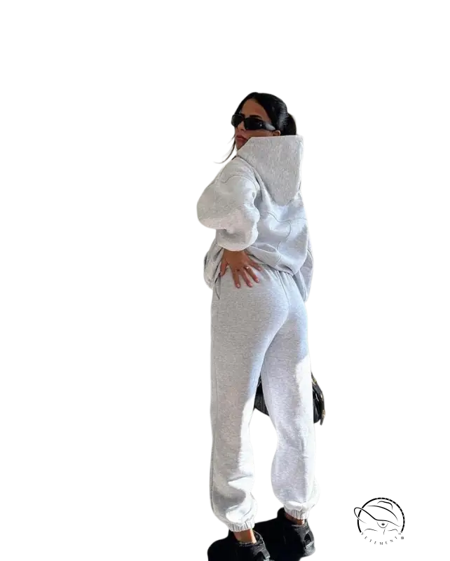 Woman in white casual comfy sweaters two-piece winter solid color set posing with hand on hip