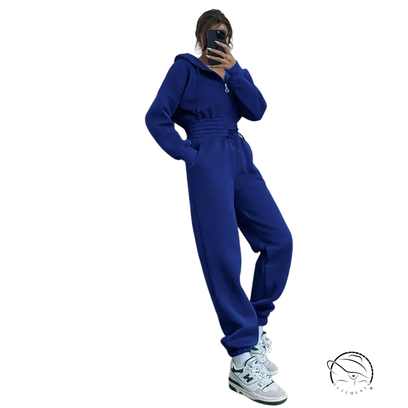 Person in bright blue casual exercise suit with hooded zipper taking mirror selfie