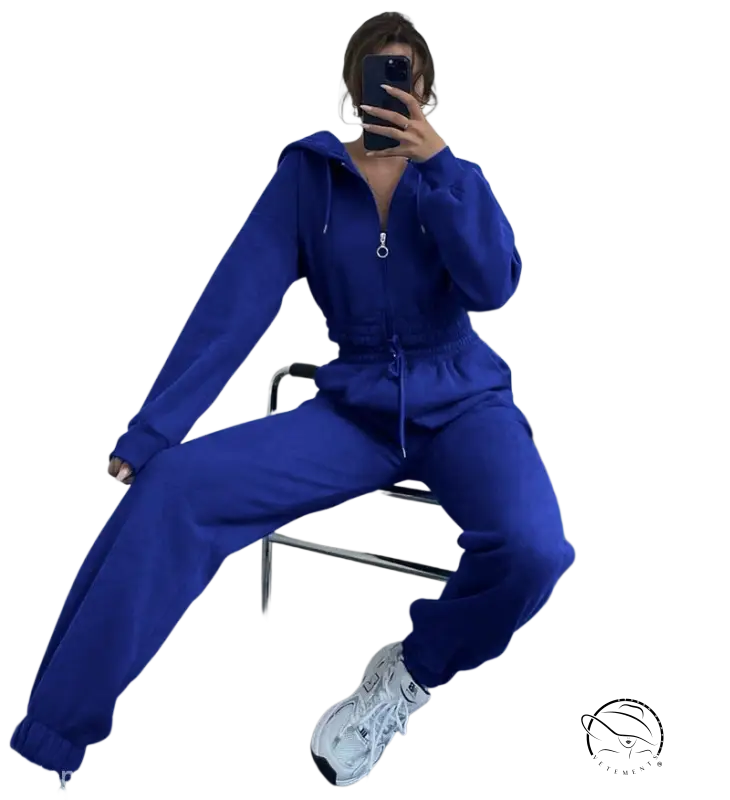 Person in bright blue casual exercise suit with hooded zipper taking mirror selfie