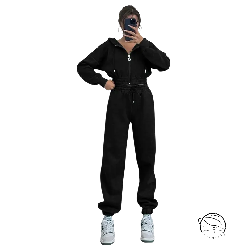 Person in black casual exercise suit with hooded zipper taking mirror selfie