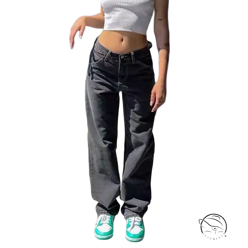 Person in white crop top, wide leg light blue jeans, and green sneakers