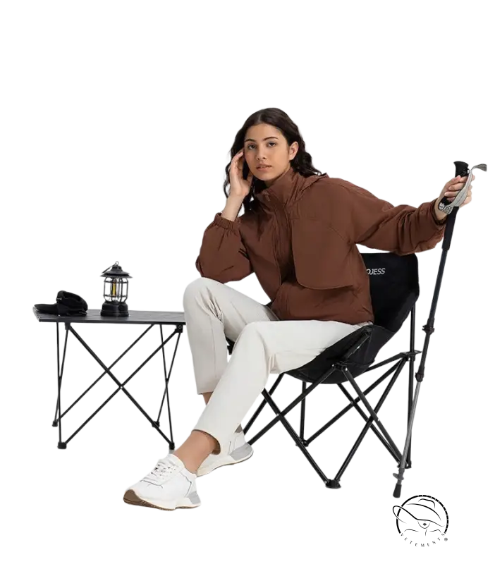 Woman in pearlescent white albumin jacket and white pants on black chair