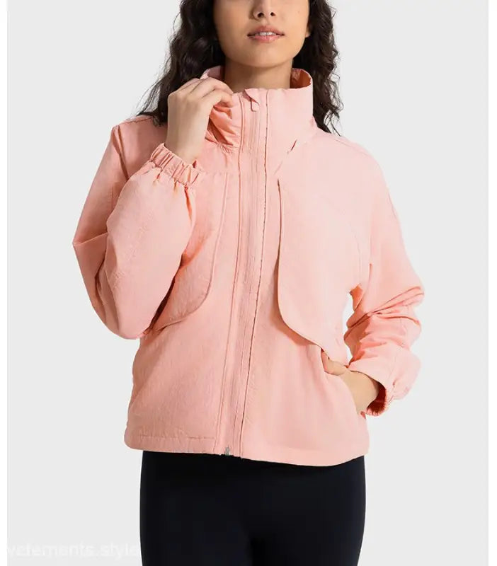 Salmon-colored zip-up jacket in Pearlescent White Albumin with green turquoise accents