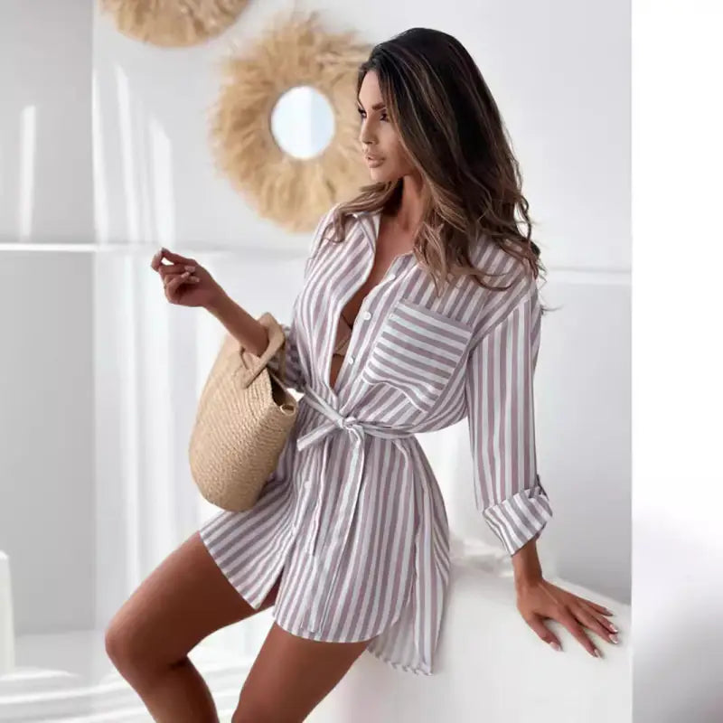 Casual mid length shirt dress with blue stripes, tie waist, and pockets
