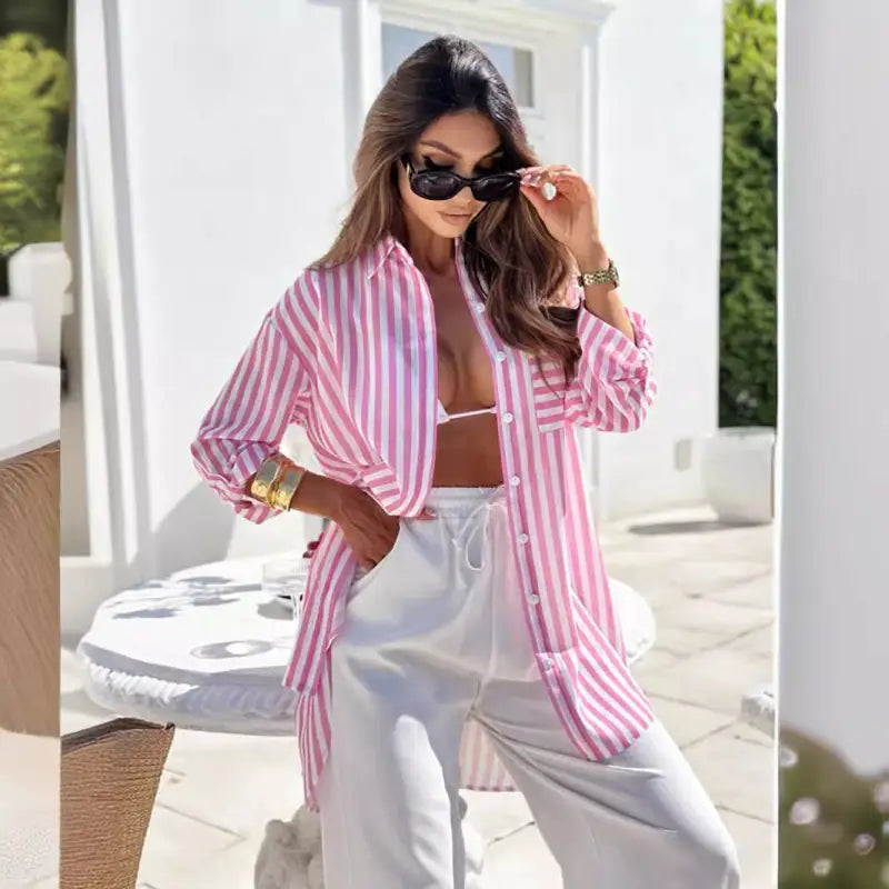 Woman in pink striped shirt dress with blue stripes and pockets, casual mid length shirt style