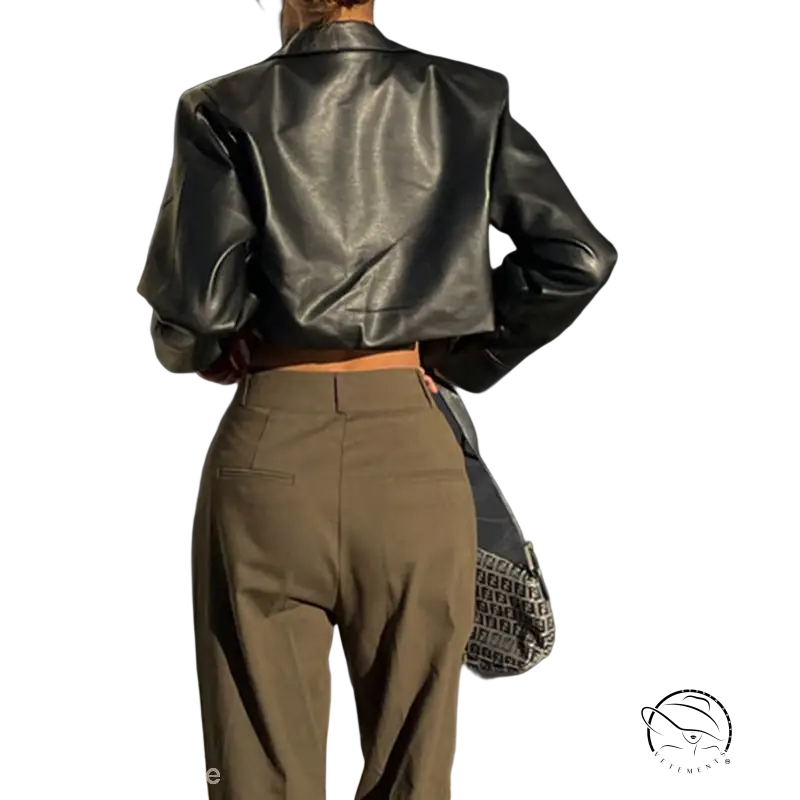 Black leather cropped motorcycle jacket paired with high-waisted tan trousers, stylish and versatile