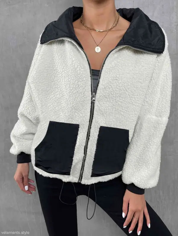 White fleece urban knitted jacket with black trim, pockets, and zipper for autumn winter comfort