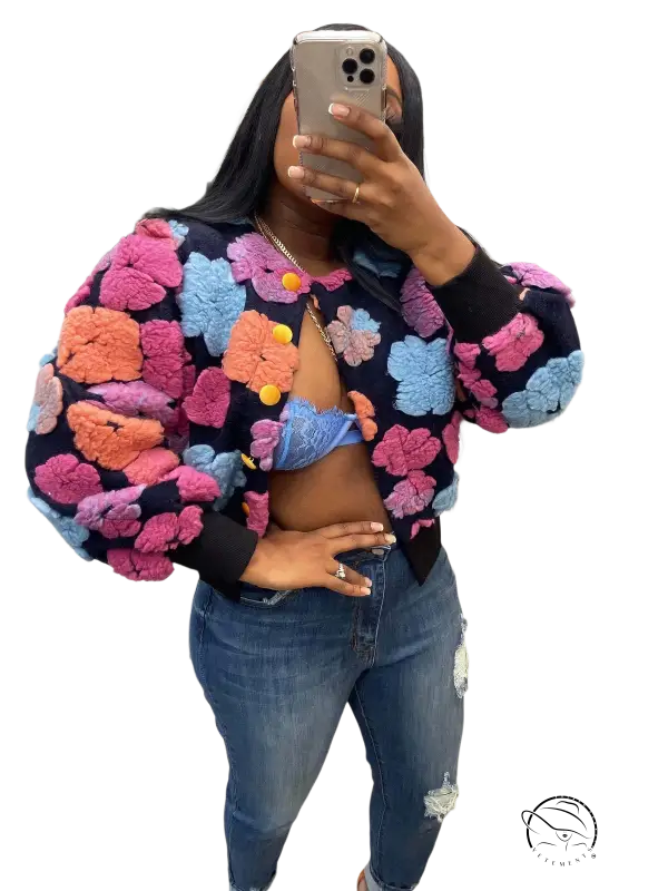 Rose red Chrysanthemum floral print bomber jacket with pom-poms and denim jeans on black background