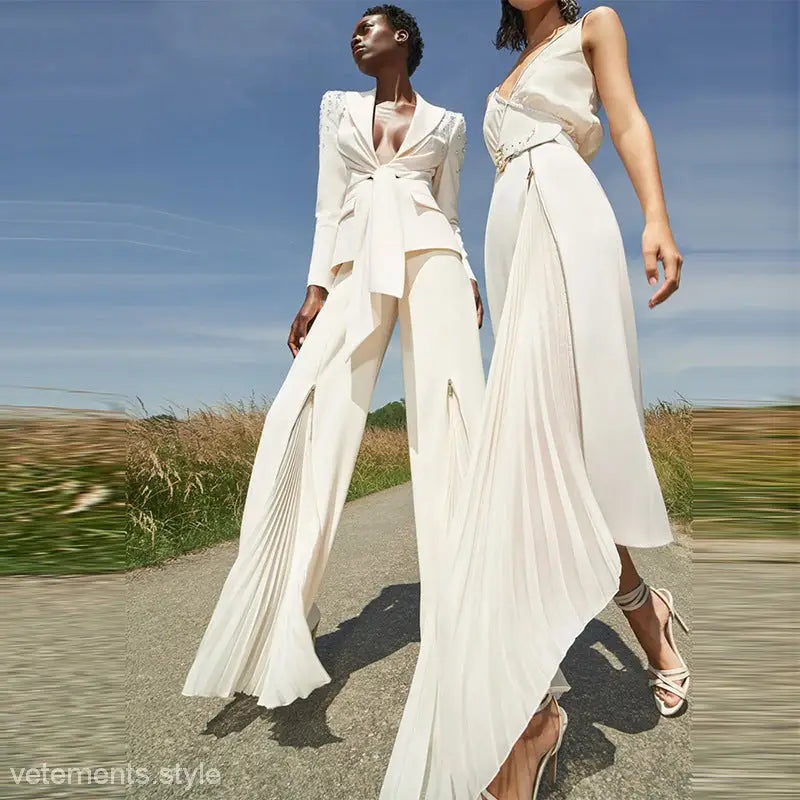 Two women in white outfits showcasing the Clara Blazer Suit and Zipper Trousers Lace