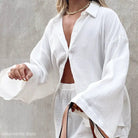 White cotton pajamas set featuring button sleeves and pockets for ultimate comfort