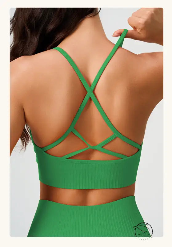 Green ribbed sports bra with crisscross straps in peach blossom pink