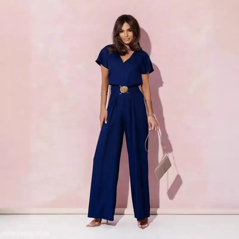 Woman wearing navy blue casual trousers jumpsuit with belt, ideal for stylish occasions