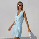 Light blue vest and skirt set styled with a dark green linen suit for summer office wear