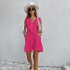 Woman in light pink linen suit paired with a dark green faux linen summer top