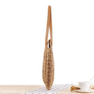 Woven straw handbag with tan leather straps for a large striped blue or light brown cross bohemian bag