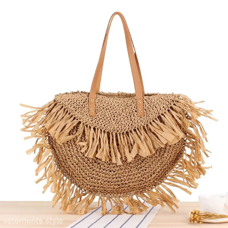 Round straw tote bag with fringe features a durable semicircle tassel shoulder design