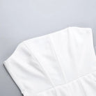 White sleeveless top with structured bodice detailing.