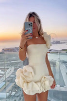 Woman in elegant white summer dress ruffled with asymmetric one-shoulder design
