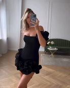 Black off-the-shoulder summer dress with ruffled, asymmetric design and one shoulder sleeve