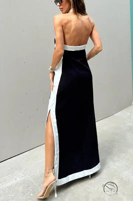 Long black and white backless evening gown with a side slit.