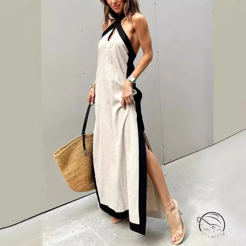 Long white halter dress with black trim and side slit.