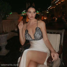 Elegant white dress with black lace bodice featuring a split design and backless lace detail