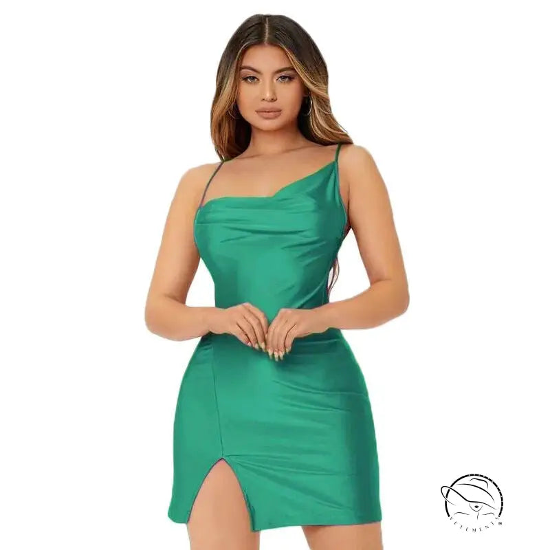 Woman in sexy backless spaghetti straps dress with green fabric and side slit