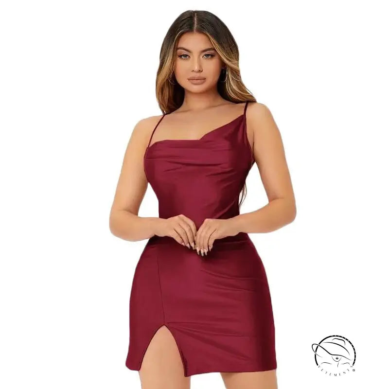 Woman in sexy backless spaghetti straps dress with burgundy hue and side slit