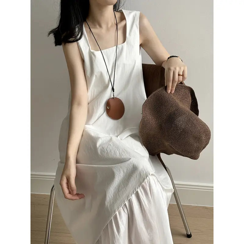 White sleeveless maxi hem stitching dress with ruffled hem and pocket detail