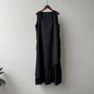 Black sleeveless hem stitching dress with asymmetrical ruffled hem on wooden hanger