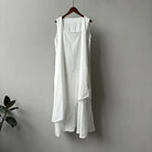 White sleeveless hem stitching dress with asymmetrical layers on wooden hanger