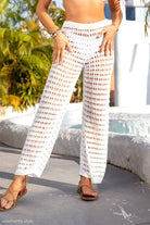 Crocheted white summer beach pants with lace and tulle accents for elegant beach wear