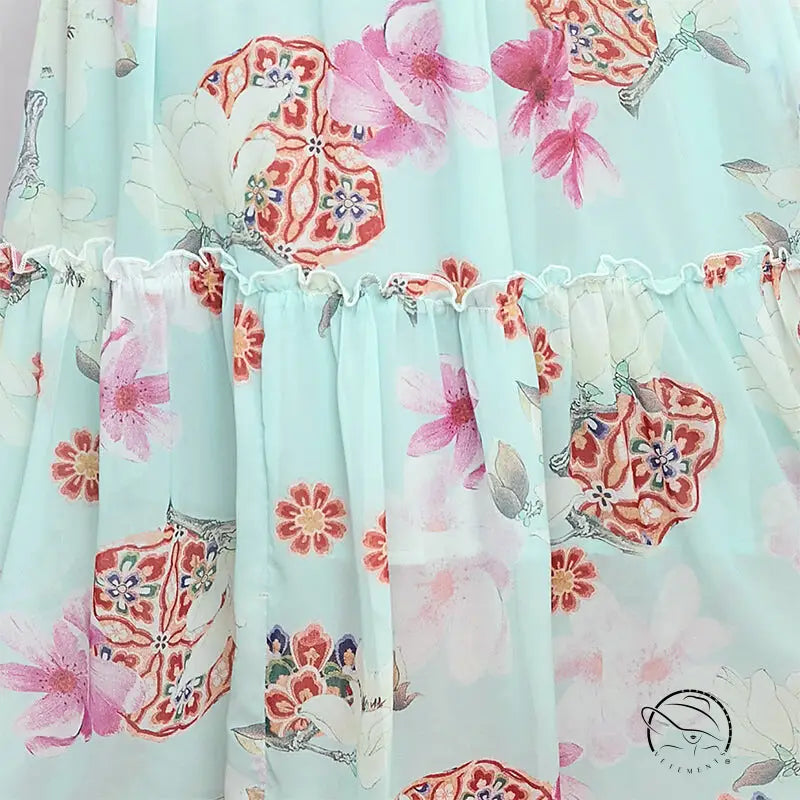 Elegant evening maxi dress in light blue floral print with ruffled seam