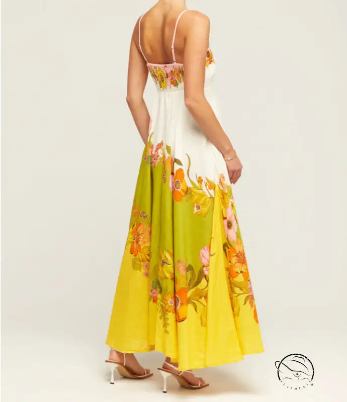 Floral maxi dress with a white bodice and yellow skirt featuring colorful flower prints.