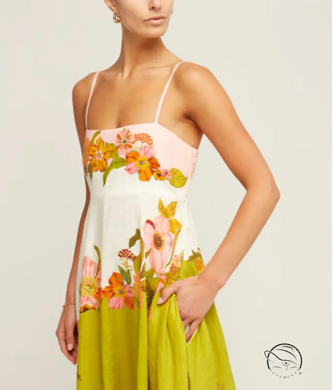 Floral sundress with spaghetti straps featuring a colorful pattern of flowers on a white, pink, and lime green background.