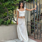 Woman in white crop top and long lace stitching skirt from Elegant French Collar collection