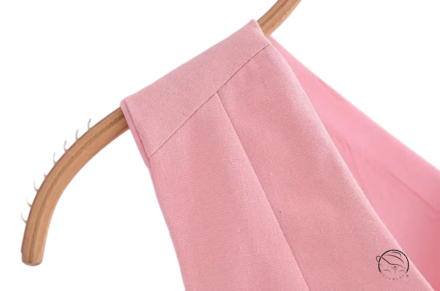 Pink garment on hanger showcasing elegant French style sleeveless V-neck polyester
