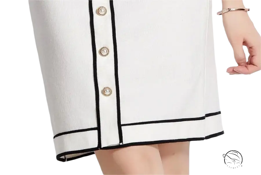 Elegant high rise long sleeve top with white skirt black trim gold buttons