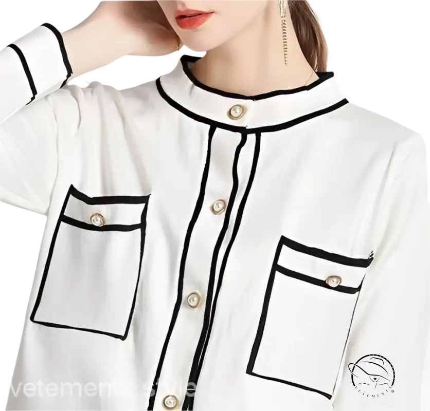 Elegant high rise long sleeve top with white blouse, black trim, decorative buttons, and short skirt set