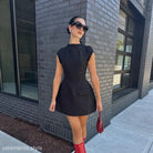 Black high waist short dress with pockets paired with bold red boots for summer style