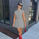 Gray high waist short dress with pockets paired with stylish red boots for summer wear