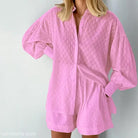 Pink two-piece shorts set featuring elegant design for a stylish office suit look